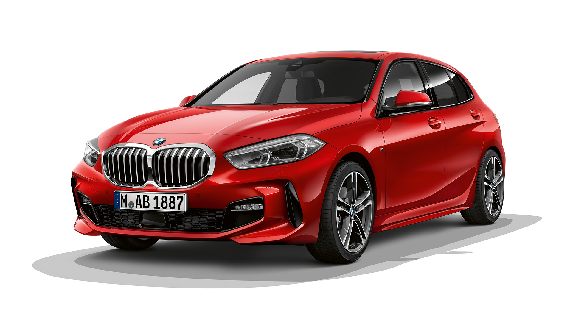 BMW 1 серии модель M Sport, вид спереди с поворотом в три четверти. BMW 1 серии модель M Sport в Melbourne Red металлик, студийный снимок спереди с поворотом в три четверти.