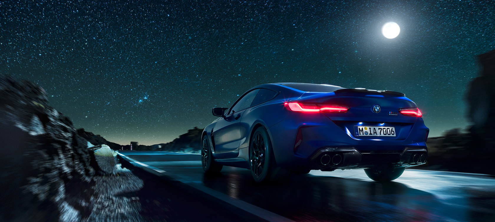 BMW M8 Competition Coupé, вид сзади. BMW M8 Competition Coupé, вид сзади, езда ночью при полной луне.