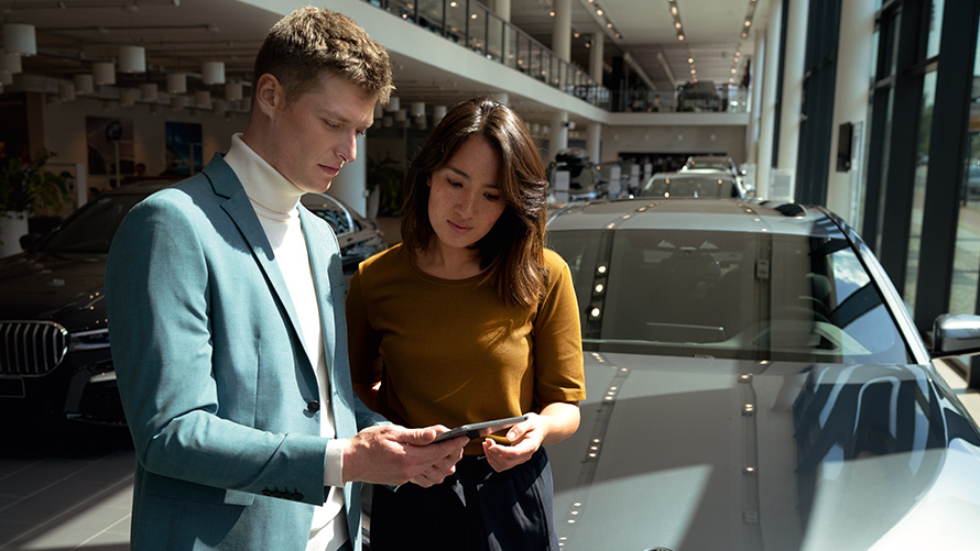 Сотрудник BMW консультирует клиента Сотрудник BMW консультирует клиента